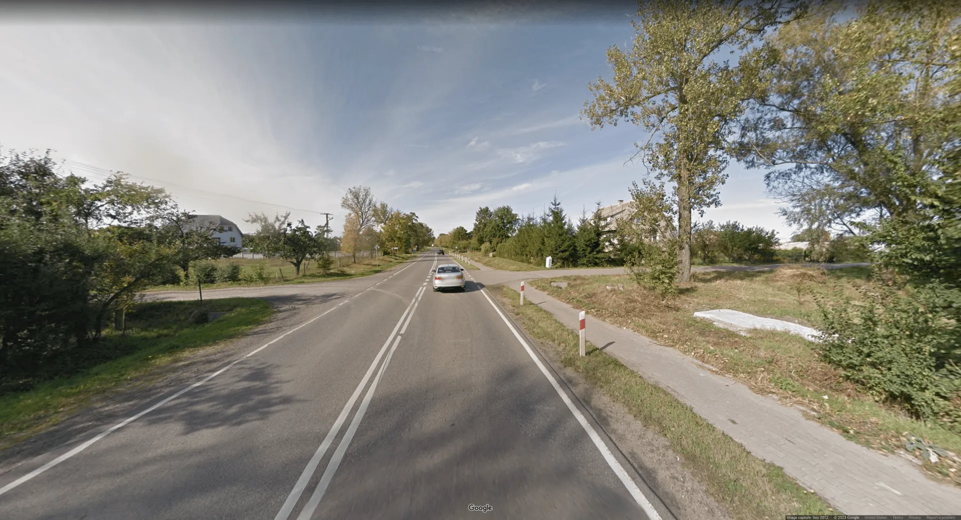 Picture of a sparsely green suburban neighborhood, with not many houses